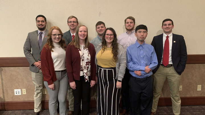 The University's meat judging team posing in a hallway.