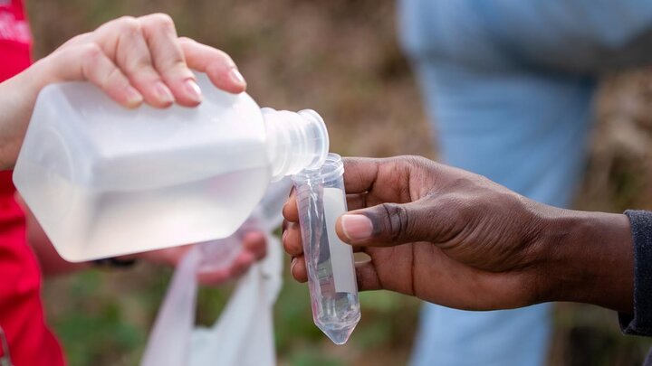 Water being poured into a scientific vile.