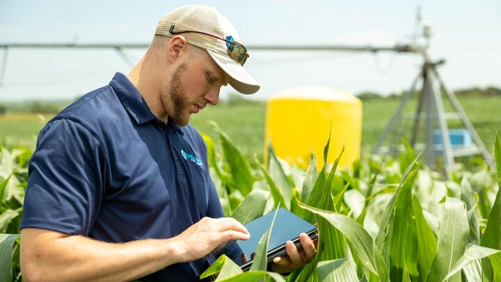 The founder of Sentinel Fertigation, Jackson Stansell, using technology in a corn field.